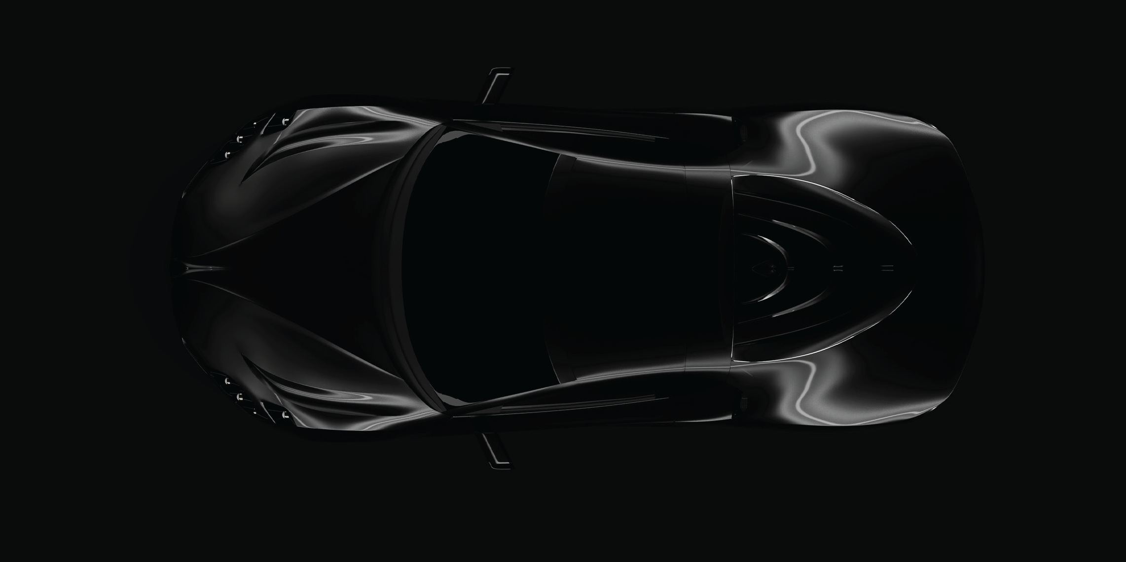 Evangelum from directly above under a single studio light: long front wings, a narrow glasshouse and the ribbed rear deck traced in highlights.